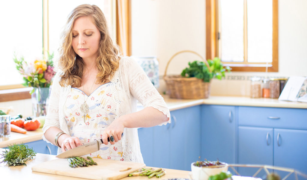 Karla Rawles, Naturopath, preparing a healthy meal in her kitchen